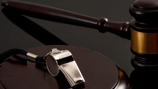 Whistleblower protection law and freedom of information legislation conceptual idea with metal whistle and wooden judge gavel on dark background