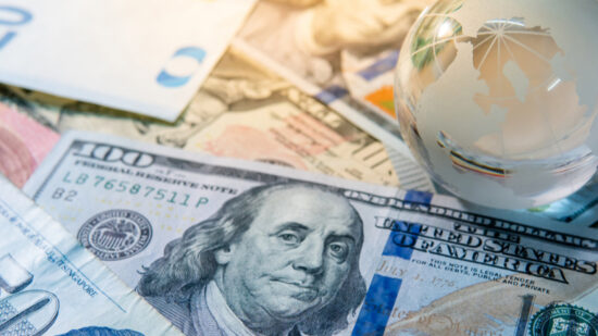 Global business and economy. World globe crystal glass on various international money banknotes. Currency exchange rate. Financial investment concept-shutterstock_1208760601