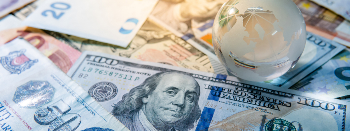 Global business and economy. World globe crystal glass on various international money banknotes. Currency exchange rate. Financial investment concept-shutterstock_1208760601